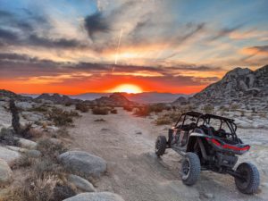 utv in the desert at sunset